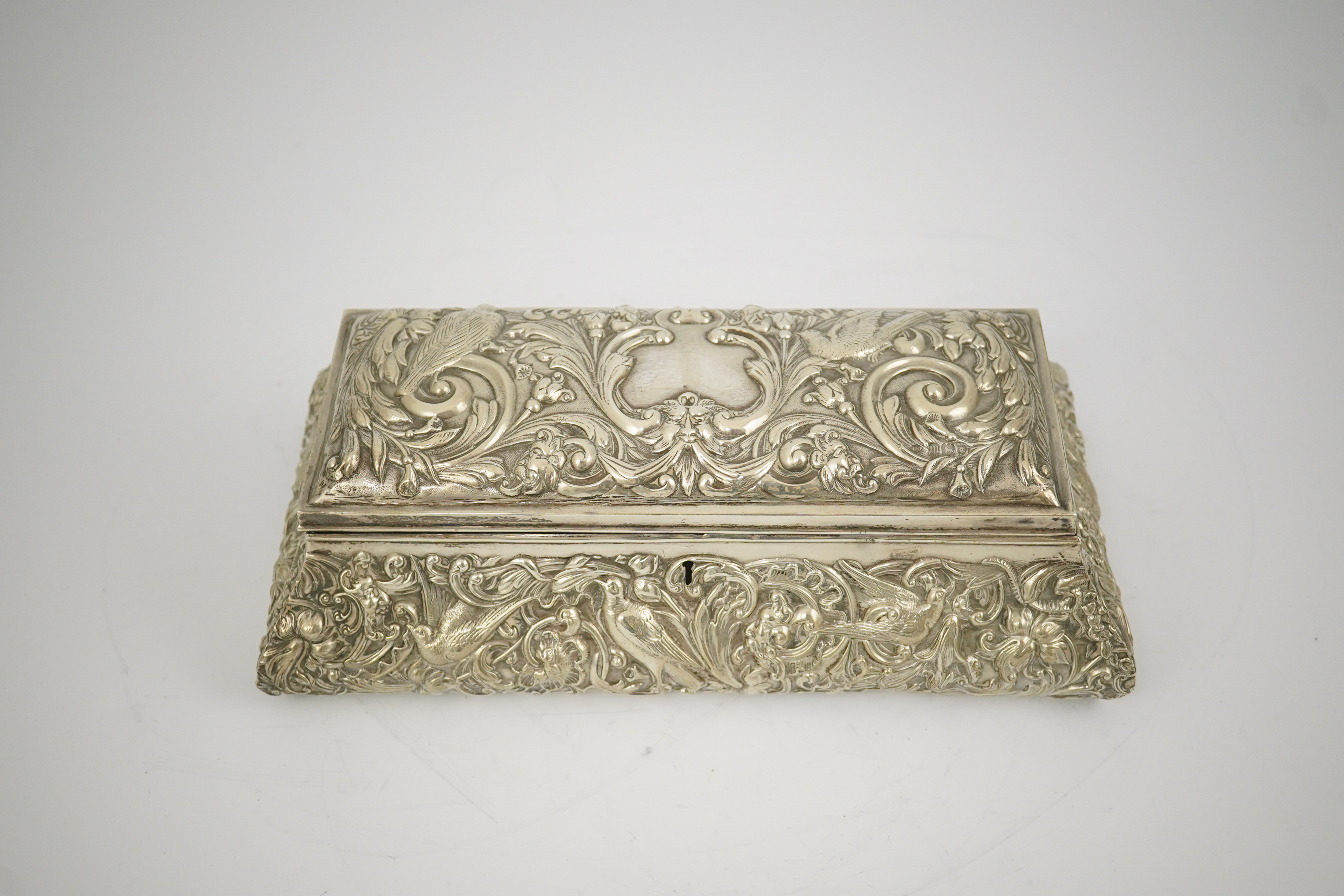 An Edwardian repousse silver mounted jewellery casket, by William Comyns